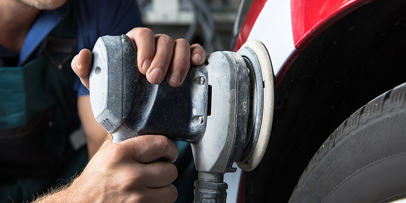 Auto technician polishing vehicle during auto body repair in Hot Springs SD