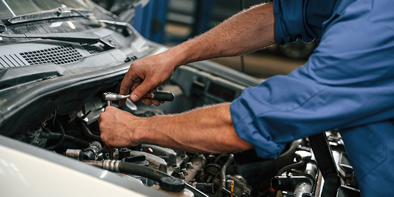 Auto technician performing engine repair at auto shop in Hot Springs SD